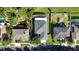 Aerial view of the property showcasing a backyard with pond, screened-in pool, and neighboring houses at 14308 Abington Heights Dr, Orlando, FL 32828