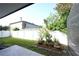 Fenced backyard featuring well-maintained lawn and mulched flowerbeds, perfect for outdoor enjoyment at 14308 Abington Heights Dr, Orlando, FL 32828