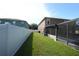 Private fenced backyard with lush lawn area and screened lanai, ideal for relaxation and recreation at 14308 Abington Heights Dr, Orlando, FL 32828