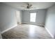 A bright and airy bedroom with wood floors, neutral walls, closet, and ample natural light at 14308 Abington Heights Dr, Orlando, FL 32828