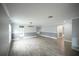 Spacious living area with gray walls, wood floors, and modern lighting, offering a versatile space for various uses at 14308 Abington Heights Dr, Orlando, FL 32828
