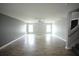 Large, open living space features wood flooring, neutral paint, and staircase at 14308 Abington Heights Dr, Orlando, FL 32828
