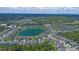 Vast aerial view of a neighborhood encircling a lake, framed by mature trees at 1529 Chelsea Manor Cir, Deland, FL 32724