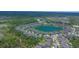 Panoramic aerial view of a residential area built around a serene central lake at 1529 Chelsea Manor Cir, Deland, FL 32724
