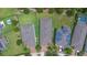 Aerial view showcases three houses with well-maintained lawns and a pool in the backyard at 1529 Chelsea Manor Cir, Deland, FL 32724