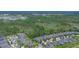 Scenic aerial view of a neighborhood bordering a dense forest and wetlands area at 1529 Chelsea Manor Cir, Deland, FL 32724