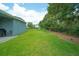 Well-maintained backyard with lush green grass and privacy fencing at 1529 Chelsea Manor Cir, Deland, FL 32724