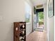 Inviting entryway with wood-look tile flooring and decorative shoe shelf at 1529 Chelsea Manor Cir, Deland, FL 32724
