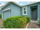 Charming single-story home with a brick walkway, lush landscaping, and a welcoming blue exterior at 1529 Chelsea Manor Cir, Deland, FL 32724