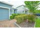 Charming single-story home with a brick driveway, lush landscaping, and a welcoming blue exterior at 1529 Chelsea Manor Cir, Deland, FL 32724
