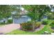 Charming single-story home with a brick driveway, lush landscaping, and a welcoming blue exterior at 1529 Chelsea Manor Cir, Deland, FL 32724
