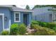 Charming single-story home with a brick walkway, lush landscaping, and a welcoming blue exterior at 1529 Chelsea Manor Cir, Deland, FL 32724