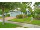 Charming one-story home with an attached garage, driveway, manicured lawn, and mature landscaping at 1529 Chelsea Manor Cir, Deland, FL 32724