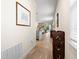 Hallway featuring neutral decor, wood-look flooring, and an open flow into the kitchen and living areas at 1529 Chelsea Manor Cir, Deland, FL 32724