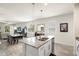 Bright kitchen island with granite countertops overlooks the dining and living areas at 1529 Chelsea Manor Cir, Deland, FL 32724