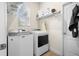 Functional laundry room with washer, dryer, and overhead shelving at 1529 Chelsea Manor Cir, Deland, FL 32724