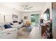 Comfortable living area with white furniture, area rug and view of the patio at 1529 Chelsea Manor Cir, Deland, FL 32724