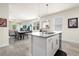 Open concept living spaces featuring kitchen, dining, and living room with sliding doors at 1529 Chelsea Manor Cir, Deland, FL 32724