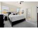 Bedroom featuring a king size bed, ensuite bath, and large windows at 1529 Chelsea Manor Cir, Deland, FL 32724