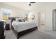 Bright bedroom showing en suite bathroom with king bed, side tables, dresser and mirror at 1529 Chelsea Manor Cir, Deland, FL 32724