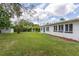 A beautiful backyard with lush green lawn and exterior of home in view at 1801 Palm Ln, Orlando, FL 32803