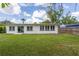 Exterior view of the backyard with green lawn and white siding at 1801 Palm Ln, Orlando, FL 32803
