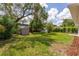 Backyard view featuring green grass and a storage shed at 1801 Palm Ln, Orlando, FL 32803