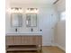 Bathroom featuring double sinks, modern fixtures, and a view of the shower in the mirror at 1801 Palm Ln, Orlando, FL 32803