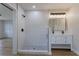 Modern bathroom featuring a glass-enclosed shower with white tile and a double sink vanity with a large mirror at 1801 Palm Ln, Orlando, FL 32803