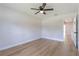 Bright bedroom featuring a ceiling fan, wood-look flooring, and a window at 1801 Palm Ln, Orlando, FL 32803