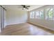 Bedroom featuring hard wood floors, three windows, and a ceiling fan at 1801 Palm Ln, Orlando, FL 32803