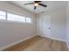 Bright bedroom featuring a ceiling fan, wood-look flooring, a window, and closets at 1801 Palm Ln, Orlando, FL 32803