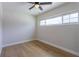 Bright bedroom featuring a ceiling fan, wood-look flooring, and a window at 1801 Palm Ln, Orlando, FL 32803