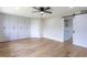 Bedroom featuring hardwood floors, ceiling fan and a sliding door to the bathroom at 1801 Palm Ln, Orlando, FL 32803
