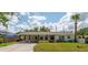 Charming single story home with a car port and lovely landscaping on a sunny day at 1801 Palm Ln, Orlando, FL 32803