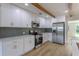 New kitchen with white cabinets, stainless appliances, and a subway tile backsplash at 1801 Palm Ln, Orlando, FL 32803