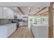 Modern white kitchen featuring an island, stainless steel appliances, and subway tile backsplash at 1801 Palm Ln, Orlando, FL 32803