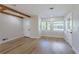 Bright living room featuring exposed beams, lots of light, and luxury vinyl flooring at 1801 Palm Ln, Orlando, FL 32803