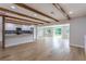 Open concept: living room with exposed beams and a large kitchen with an island and stainless appliances at 1801 Palm Ln, Orlando, FL 32803