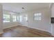 Bright open living room, featuring light wood floors and a white door to the exterior at 1801 Palm Ln, Orlando, FL 32803