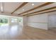 Bright, open concept living room with exposed beams and luxury vinyl flooring at 1801 Palm Ln, Orlando, FL 32803