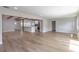 Spacious living room with light wood floors, wooden beams, and access to the modern kitchen at 1801 Palm Ln, Orlando, FL 32803