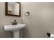 Compact bathroom with a pedestal sink, bronze fixtures and a mirror at 1815 Big Oak Ln, Kissimmee, FL 34746