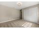 Cozy bedroom featuring neutral walls, carpet, and a closet with white doors at 1815 Big Oak Ln, Kissimmee, FL 34746