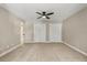 Neutral bedroom with carpet, a ceiling fan, and a closet with white doors at 1815 Big Oak Ln, Kissimmee, FL 34746