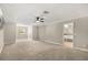 A spacious bedroom features a ceiling fan, neutral tones, and view from the window at 1815 Big Oak Ln, Kissimmee, FL 34746