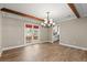 Open dining area featuring wood-look tile floors, wood beams, and lots of light at 1815 Big Oak Ln, Kissimmee, FL 34746