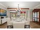 Elegant dining room boasting bright lighting, an ornate chandelier, and comfortable seating at 1815 Big Oak Ln, Kissimmee, FL 34746