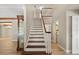 Inviting foyer featuring wood stairs, light walls, and wood-look floors at 1815 Big Oak Ln, Kissimmee, FL 34746