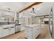 Bright kitchen features farmhouse sink, updated cabinetry, blue backsplash, and island at 1815 Big Oak Ln, Kissimmee, FL 34746